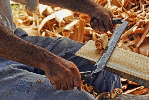 man working wood with his hands